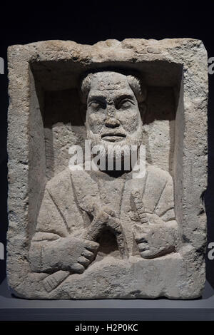 Funeral stone of a Roman artisan from the end of the 2nd or the beginning of the 3rd century AD discovered in 1826 in Bordeaux and currently displayed in the Museum of Aquitaine (Musee d'Aquitaine) in Bordeaux, France. The unknown artisan holds an adze, a Roman cutting tool, in one hand and a rule in the other hand. Stock Photo