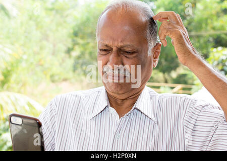Closeup portrait, gentleman with mustache in white striped shirt, dumbfounded flabbergasted by what he sees on cell phone, isola Stock Photo