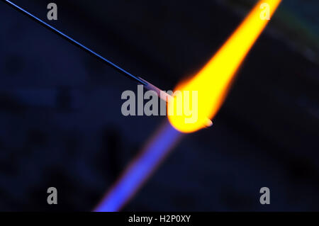 Glass is being melted under fire. Stock Photo