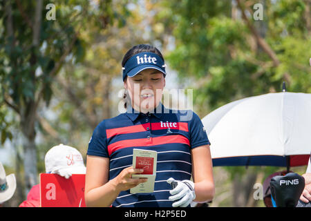In Gee Chun, of South Korea, putts with one shoe on the third green