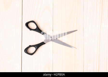 Scissors on wooden background Stock Photo