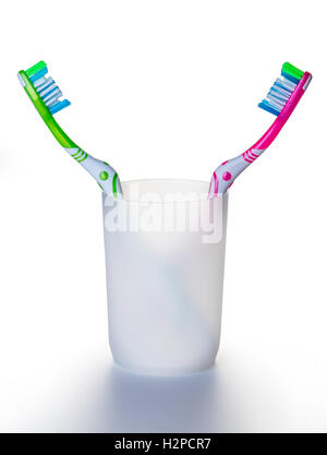 two toothbrushes in a glass on white background Stock Photo