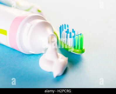 toothbrush with toothpaste close-up on blue background Stock Photo