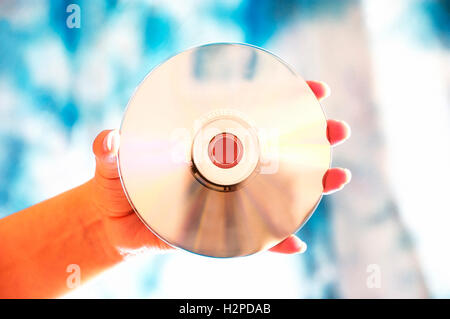 hand holding a DVD disc Stock Photo