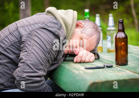 Drunk men sleeping on table Stock Photo