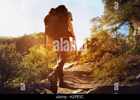 Man goes on trek uphill Stock Photo