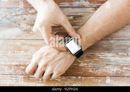 close up of hands with coding on smart watch Stock Photo