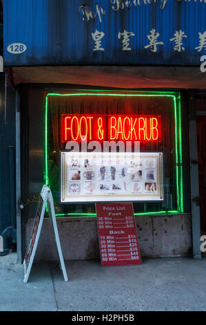 Foot & Back Rub in a Chinatown shop in New York City Stock Photo