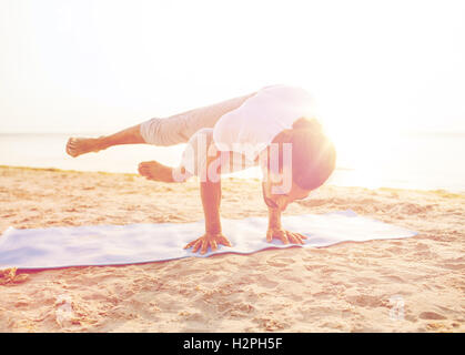 man doing yoga exercises outdoors Stock Photo