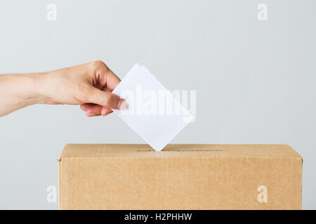 man putting his vote into ballot box on election Stock Photo