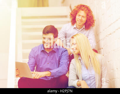 team with tablet pc computer sitting on staircase Stock Photo