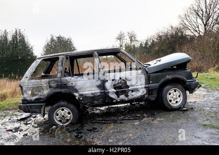 A burnt-out Range Rover abandoned in the countryside of Northumberland, England. Stock Photo