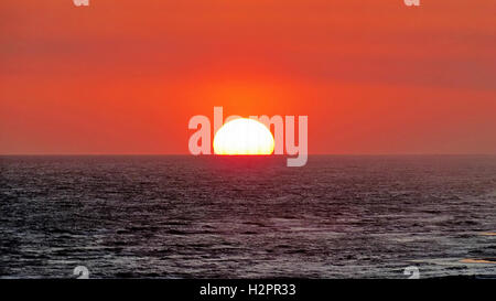 A brilliant red sun sunset over the ocean near Perdido Key, Florida Stock Photo