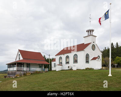 The Acadian Flag Flies in Front of the Chapel of St. Anne de Beaumont and the Presbytery which were Built in1842. Stock Photo