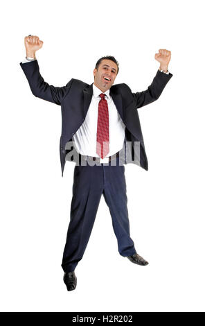 A tall handsome businessman standing for white background in a blue  suit and red tie lifting up his arms for happiness. Stock Photo