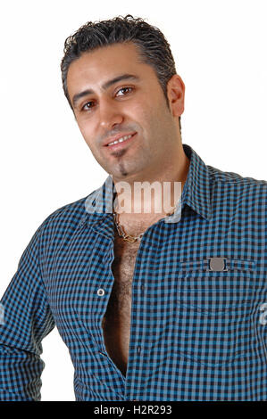 A handsome black haired man in a dark blue shirt standing smiling for white background, in a portrait picture. Stock Photo