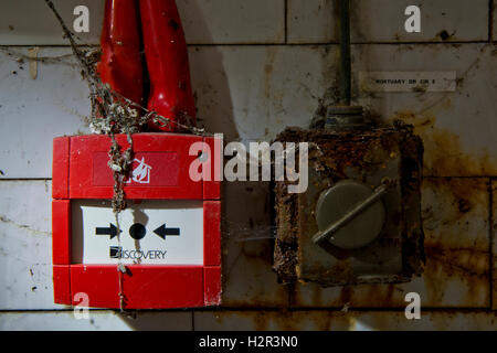 Rusty electrical switch and fire alarm within St Ann's Hospital Mortuary, Haringey, North London, UK Stock Photo