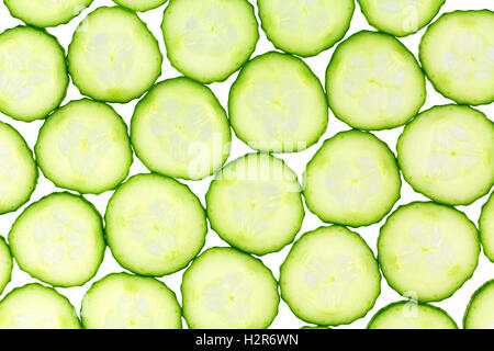 Close up of back light thinly sliced cucumbers isolated on white background. Stock Photo