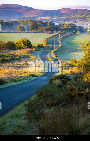 Sunrise over rural farmland of Moel-y-Crio in Flintshire with the highest point of Moel Famau in the Clwydian Range in the distance Stock Photo