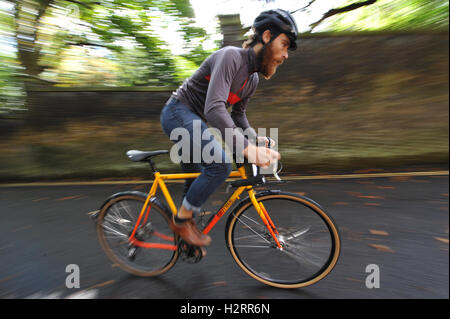 London, UK. 01st Oct, 2016. Ed Holt, a cyclist competing in the Rollapaluza Urban Hill Climb competition aggressively tacking the steepest section of the course.  The event took place on Swain’s Lane, arguably the most famous and notoriously challenging climb in London. . Credit:  Michael Preston/Alamy Live News Stock Photo