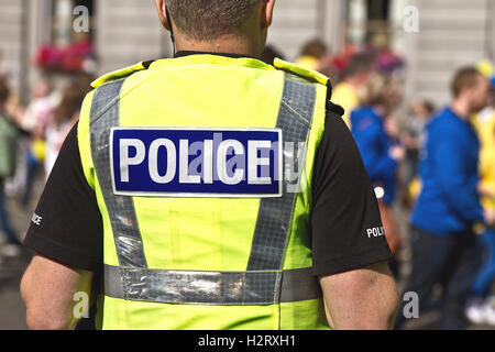Police officer in hi-visibility jacket with text Police written. UK Police officer Stock Photo