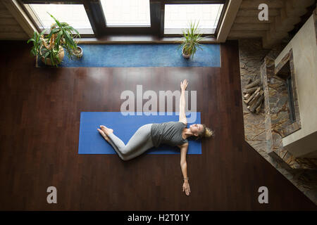 Yoga at home: Belly Twist Pose Stock Photo