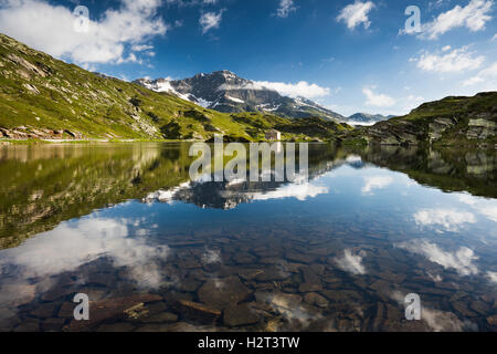 San Bernardino Pass with water reflection, Grison Alps, Graubünden Canton, Switzerland Stock Photo