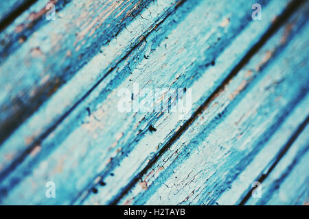 Cracked paint on blue wooden surface close up photo Stock Photo