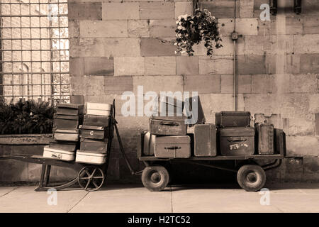 Old luggage carts at Pickering station, North Yorkshire. Image converted to black and white and given a sepia tint. Stock Photo