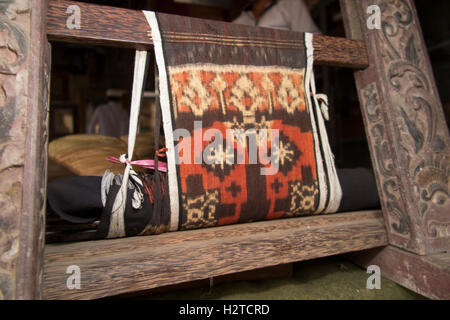 Indonesia, Bali, Tengannan, double ikat fabric being woven on backstrap loom Stock Photo