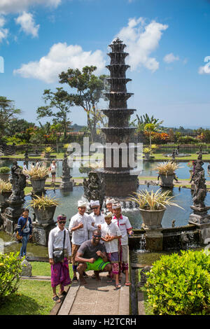 Indonesia, Bali, Tirta Gangga, Ababi, Palace, local tourists wearing traditional costume in water garden Stock Photo