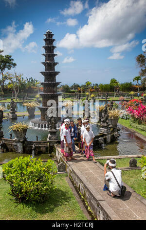 Indonesia, Bali, Tirta Gangga, Ababi, Palace, local tourists wearing traditional costume in water garden Stock Photo