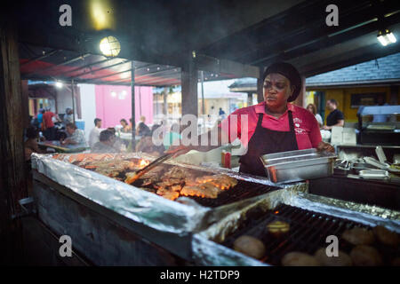 Barbados Oistins chef cook cooking   coastal town parish Christ Church fishing village tourists hang out Friday night Market baz Stock Photo