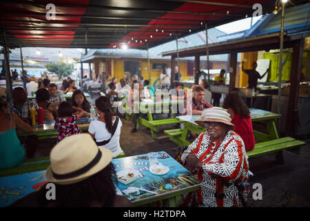 Barbados Oistins chef cook cooking   coastal town parish Christ Church fishing village tourists hang out Friday night Market baz Stock Photo