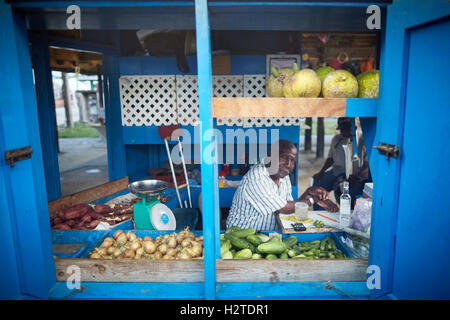 Barbados Oistins chef cook cooking   coastal town parish Christ Church fishing village small shop in the market space fruit  veg Stock Photo