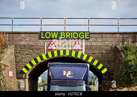 Low Bridge warning sign strike hgv lorry stuck  Adlington Manchester to Macclesfield line Transport transporter transportation t Stock Photo