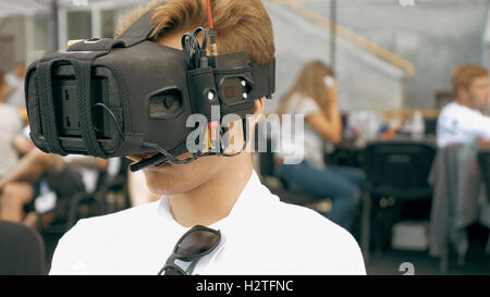 Man watching flight of FPV drone using VR glasses Stock Photo