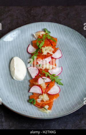 Cured sea trout with horseradish cream, cucumber chutney and micro herbs Stock Photo