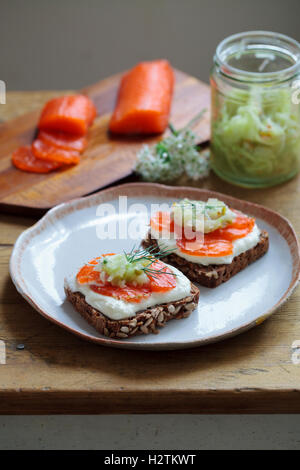 Scandinavian dark bread with cured trout , micro herbs, cucumber chutney and horseradish cream Stock Photo