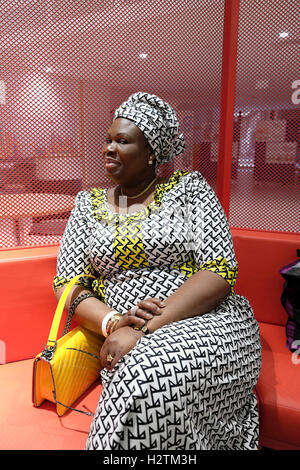 Woman in African textile print dress visiting  Guys Hospital Cancer Centre day in Southwark,  London, England, UK  KATHY DEWITT Stock Photo