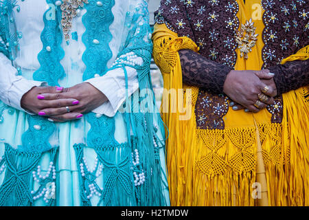 Detail of dresses and hands. At left Benita la Intocable , at right Angela la Folclorista, cholitas females wrestlers, El Alto, Stock Photo