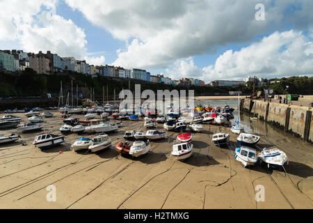 View of Tenby Harbour with fishing boats lined up awaiting the incoming tide, Pembrokeshire, Wales, Stock Photo