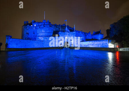 Edinburgh Castle at night bathed in Saltire Blue light Stock Photo