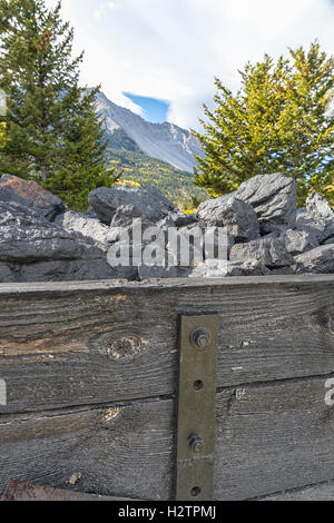 Coal cart monument at the Hillcrest Cemetery in Alberta Canada. Turtle mountain in the background Stock Photo
