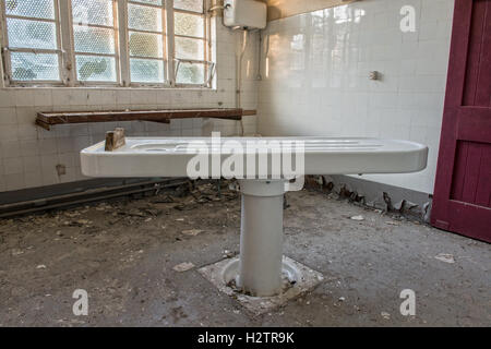 An increasingly rare porcelain autopsy table within the derelict Maiden Law Hospital Mortuary, Lanchester, County Durham, UK Stock Photo