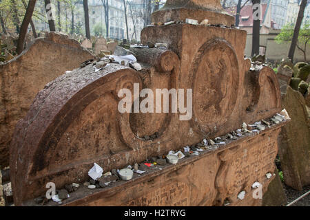 gravesOld Jewish Cemetery Prague. Sometimes visitors leave pebbles or prayers written on small pieces of paper on the tombstones. Stock Photo