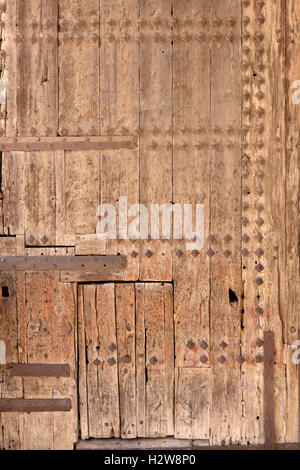 old wooden door with rusty rivets and fittings Stock Photo