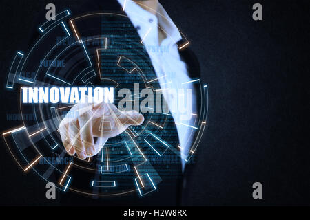 The businessman pointing the blue and orange circle of light by focusing on innovation. This picture suitable for business and t Stock Photo