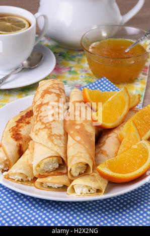 Pancakes stuffed with cottage cheese and oranges for breakfast Stock Photo
