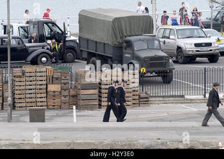Harry Styles and Tom Hardy fans wait in Weymouth, Dorset as they are due to be filming the war movie Dunkirk. Weymouth harbour has period vehicles and boats for the WWII scenes. Many streets were closed and will remain closed tomorrow as filming continues Stock Photo